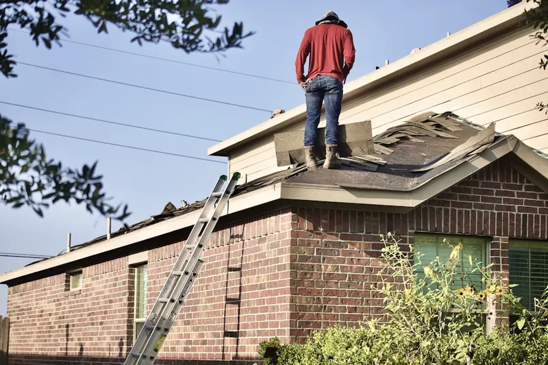 Professional roofer working on a residential roof in Hershey Mill